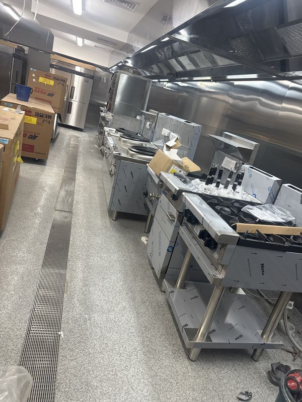 Commercial kitchen fit-out with grated floor drain