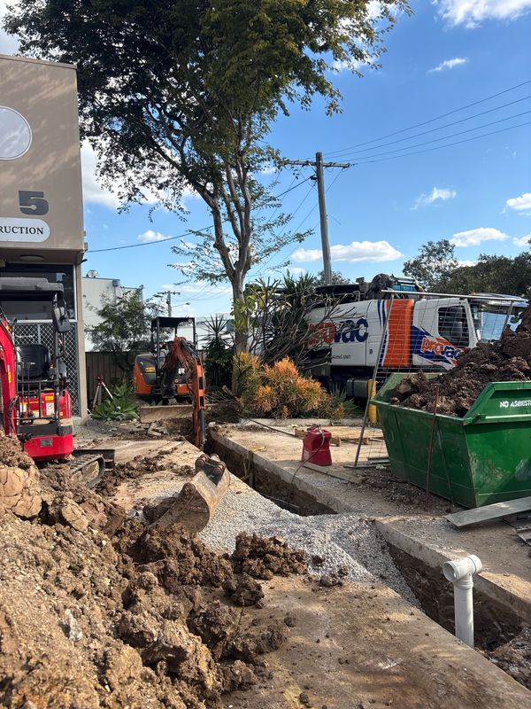 Commercial site with excavator and vacuum truck